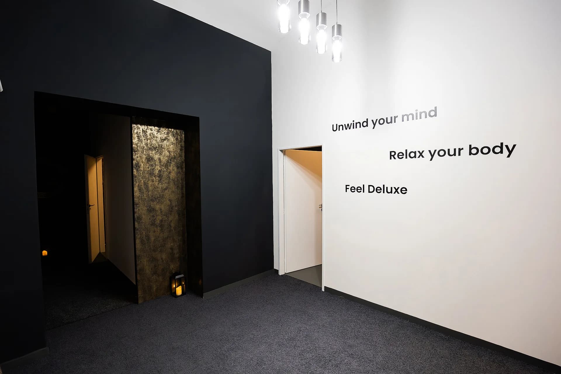 Enlarge photo: The lit street-level entrance to the Massage DeLuxe salon at Na Bělidle 63/1 in Prague 5, Smíchov